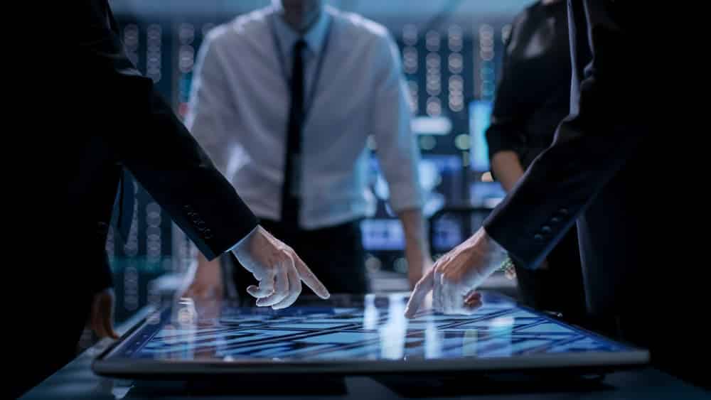 Corporate Managers Working at the Table in Monitoring Room Room